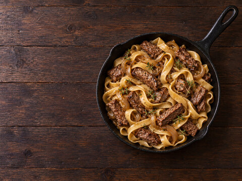 Beef Pasta with Caramelized Onions and Fresh Thyme in Skillet
