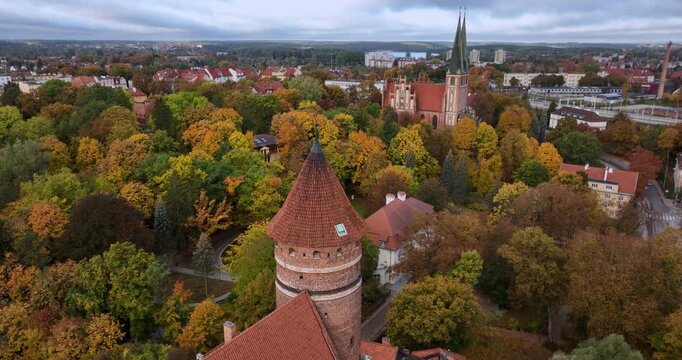 Olsztyn Castle and neo-Gothic garrison church on an autumn morning