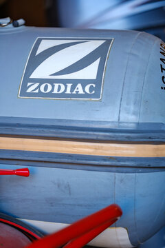 Zodiac inflatable boat tube and logo panel with a red paddle alongside