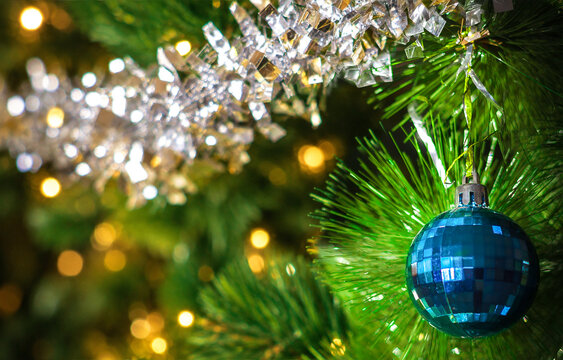 Blue Christmas Bauble on Decorated Pine Tree