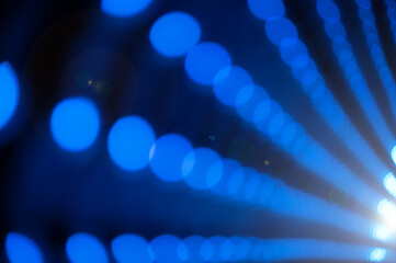 Fototapeta premium Abstract blue bokeh lights tunnel background with perspective