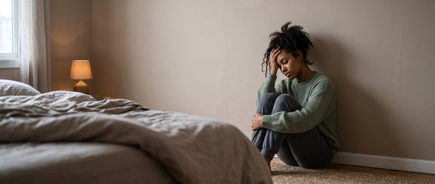 Depressed woman suffering from anxiety and migraine at home, emotional breakdown, panic attack, psychological distress, menopause, mental health awareness