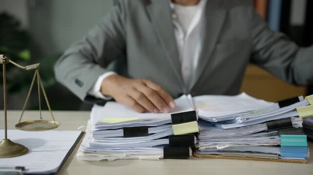 Businessman Organizing Financial Documents at Busy Office Desk