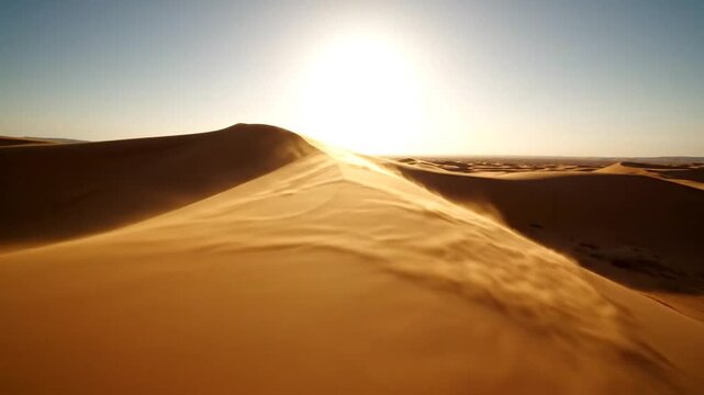Golden desert dunes at sunset with rippling sand patterns and bright sun