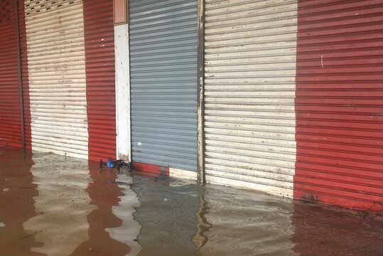 flooding on street to biulding colorful iron door in Thailand