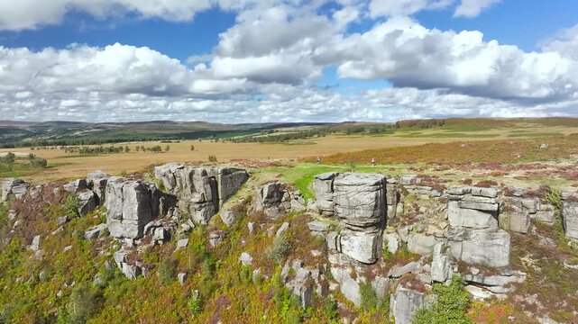 Rocks and Moorland over Curbar Edge and Hope Valley from a drone, Peak District National Park, Curbar, Calver, England, UK