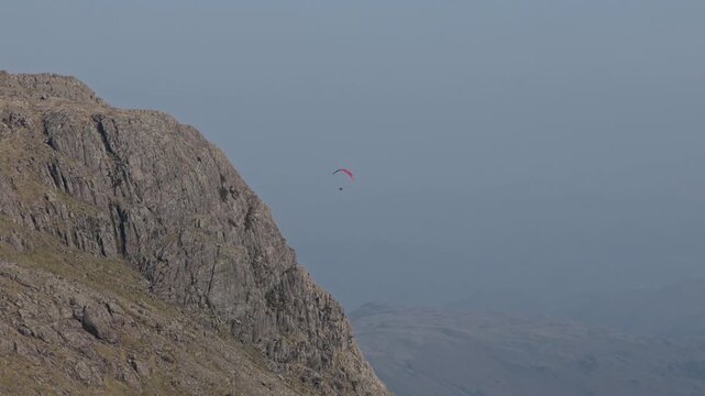 Para glider flying above the Langdales