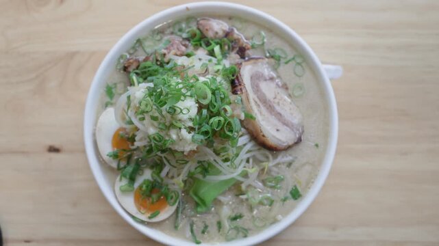 Overhead view of Jiro style ramen with pork egg and sprouts