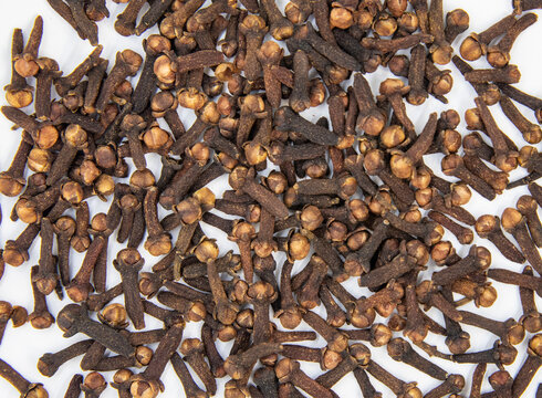Dried cloves close up showing natural spice texture. Top-down view of a background of clove spices.