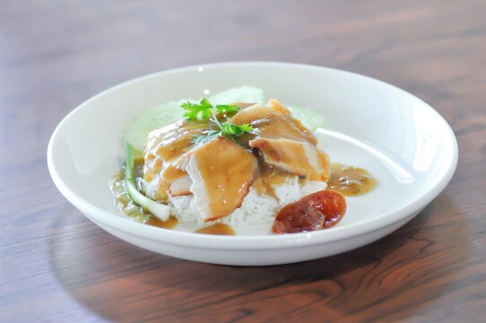 fried pork and rice or rice topped with pork with cucumber and sauce or pork and rice