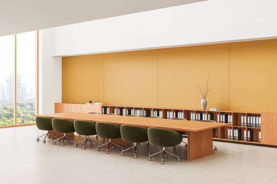 Modern warm-toned office interior design with long conference table, rolling chairs, built-in shelving and panoramic city window view. 3D Rendering