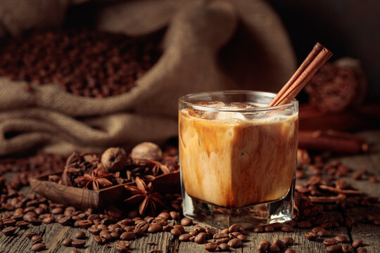 Iced coffee with cream on an old wooden table.