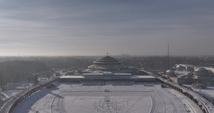 Aerial pull back from Centennial Hall and snowy Pergola in Wrocław