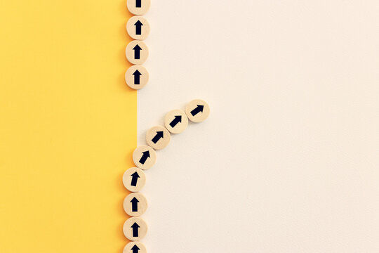 Arrows on wooden blocks, idea of thinking differently, setting goals and thinking about solution