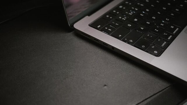 A man is inserting a USB type C connector to a laptop