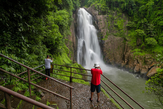 Tourist taking photos of Haew Narok Waterfall Khao Yai National Park in Thailand.