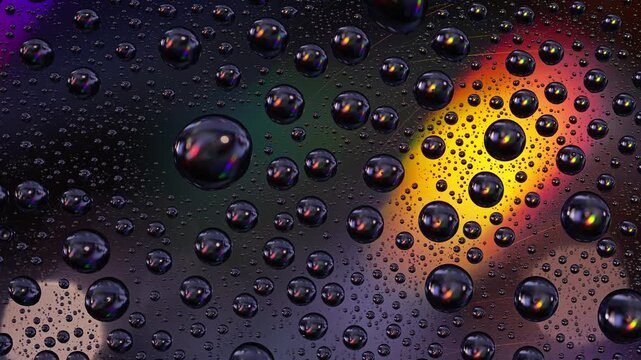 Water drops on a rotating iridescent cd with rainbow light reflections creating a colorful abstract macro background