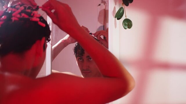 Male rubbing the hairstyling product into his curls