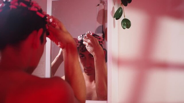 Male rubbing the hairstyling product into his curls