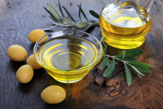 organic olive oil and olives in a glass bowl