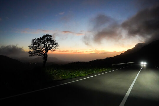 Car with headlights on the road with beautiful sunset, Santiago, Cape Verde