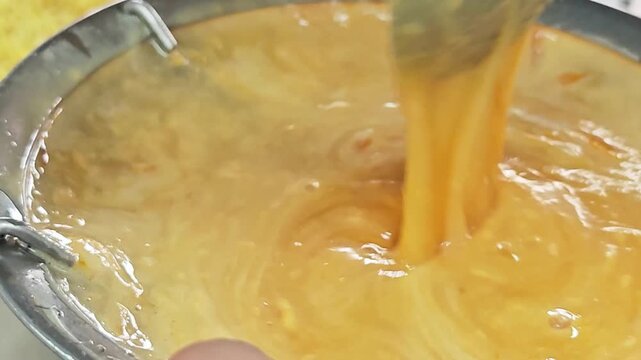 Pouring golden yellow egg yolk and sugar batter into a blender.