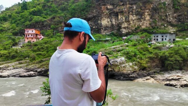 Photographer capturing river & mountain landscape in Gopeshwar Chamoli Uttarakhand India