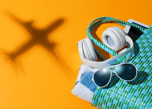 Summer Holiday Travel Concept with Headphones and Airplane Shadow