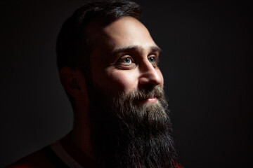 Portrait of a Bearded Man in Dramatic Lighting With a Thoughtful Expression © Loginova