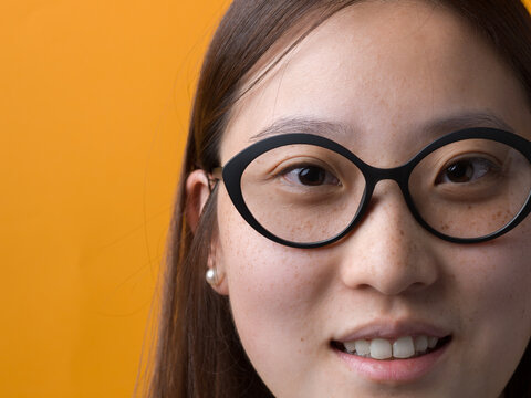 Close-Up Portrait of Young Chinese Woman with Glasses and Natural Skin