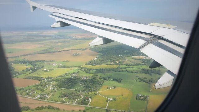 Airplane Wing Over Farmland Viewed From Passenger Window