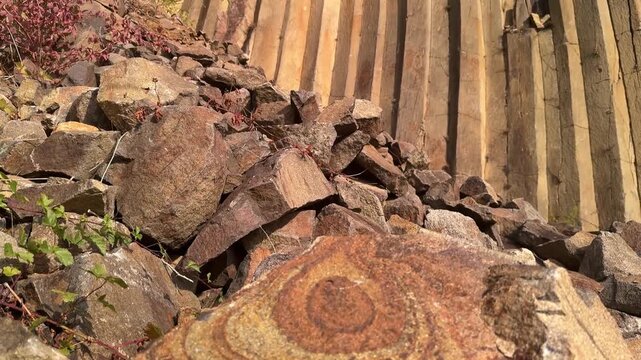 Basalt columns in Sylce village, Carpathians, with cracked basalt in foreground showing striking geometric pattern, dramatic geological heritage and scenic natural wonder