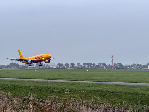 DHL Cargo plane landing at Schiphol Airport. Amsterdam, The Netherlands.