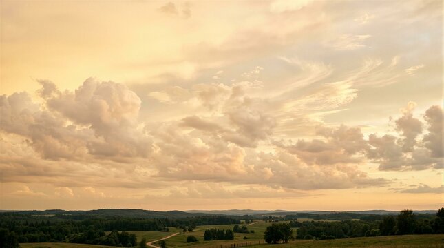 Golden sky fades above rolling green hills. Clouds drift softly, painted in amber and peach. Distant trees line the horizon, quiet and still. Lonely road winds through the countryside