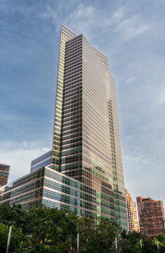New York, NY - US - Sep 25, 2026 : 7 World Trade Center rises above Lower Manhattan, its glass curtain wall reflecting the sky and sunlight above trees and surrounding buildings near the WTC complex.