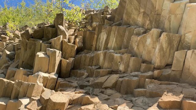 Basalt columns near Zhborivtsi in Carpathian Ukraine, towering hexagonal prisms formed by volcanic lava cooling, dramatic geological landmark in rural landscape