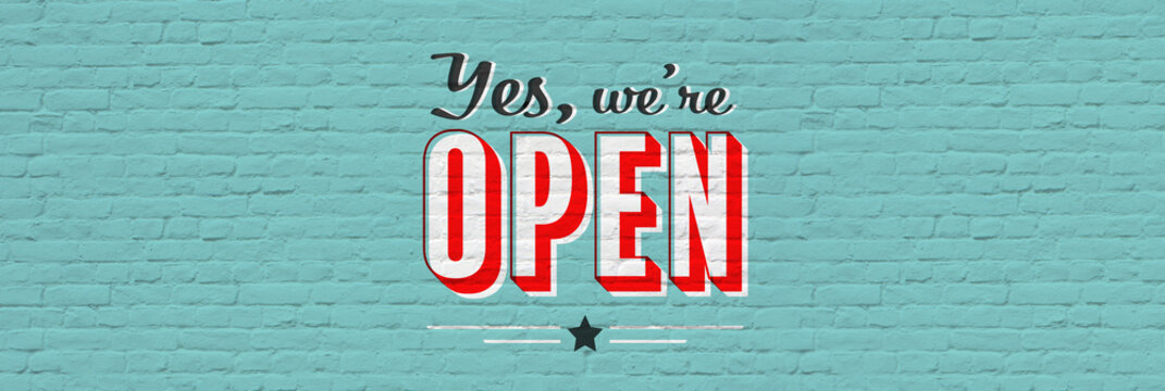 Yes we are open retro sign banner on brick background	