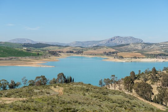 Embalse del Conde de Guadalhorce reservoir, turquoise lake in a dry landscape, dammed up River Guadalhorce, Andalusia, Spain