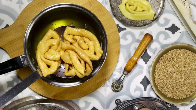 Griwech crunchy pastries , an Algerian dessert made with dough, fried and then coated with syrup and sesame seeds