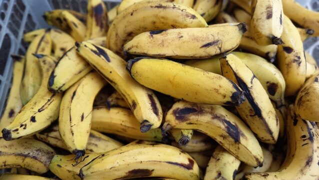Full frame yellow ripe bananas texture background with natural spots