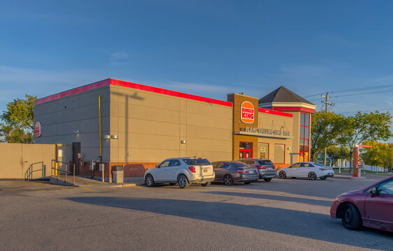Calgary, Alberta, Canada. September 27, 2026. Exterior view of a Burger King restaurant building and parking lot during daylight.