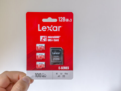 Calgary, Alberta, Canada. September 27, 2026. Hand holding a Lexar microSDXC memory card retail package against a white background.