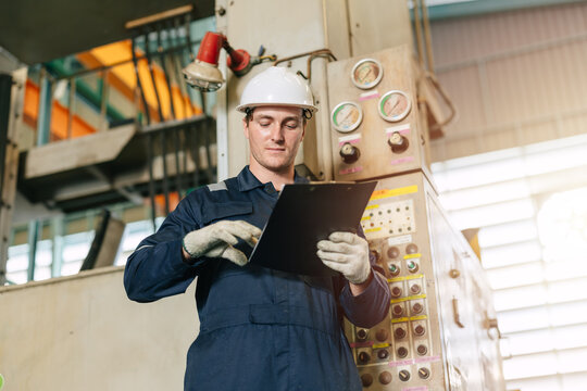 Professional factory engineer male inspecting control operate machine in industrial factory skillful
