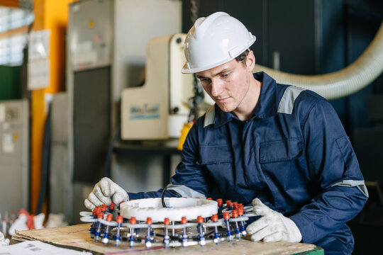 Young man worker factory engineer technician happy working in industrial in manufacturing plant