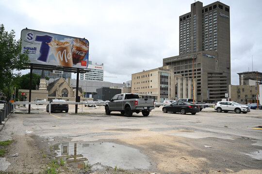 Winnipeg, Manitoba, Canada - July 2, 2026: Cars in a parking lot in downtown Winnipeg, Manitoba.