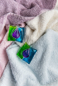 Laundry detergent pods on clean folded towels