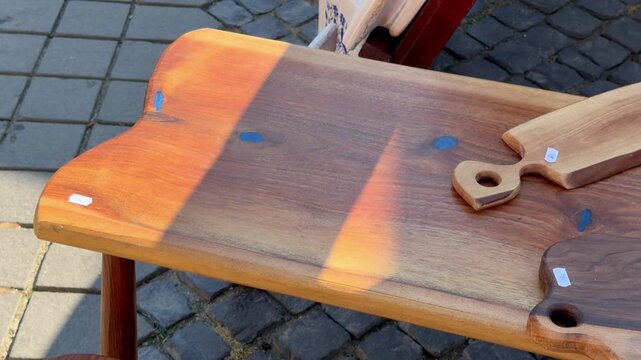 Handmade wooden tableware displayed at traditional craft market in Romania