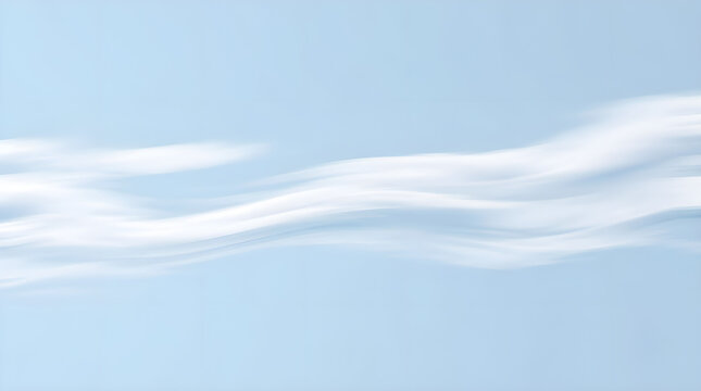 Abstract white clouds flowing across a pale blue sky with copy space