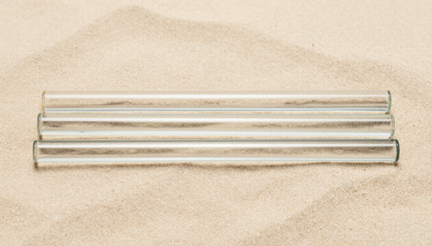Glass Rods Aligned on Pale Sand