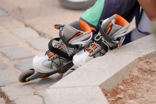 Inline skates resting on a curb after exercising outdoors